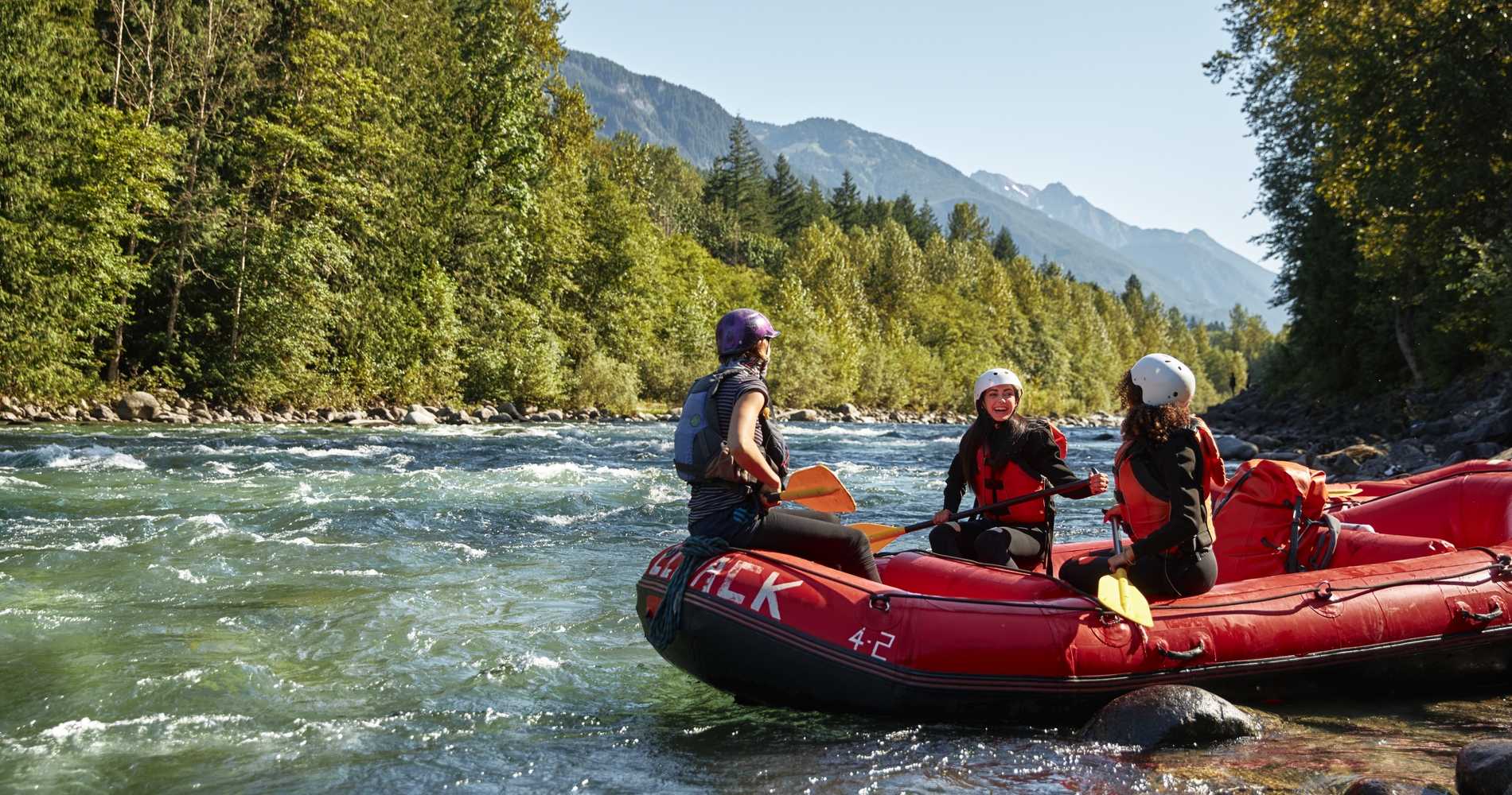 A group of friends river rafting on Vedder River | Hubert Kang