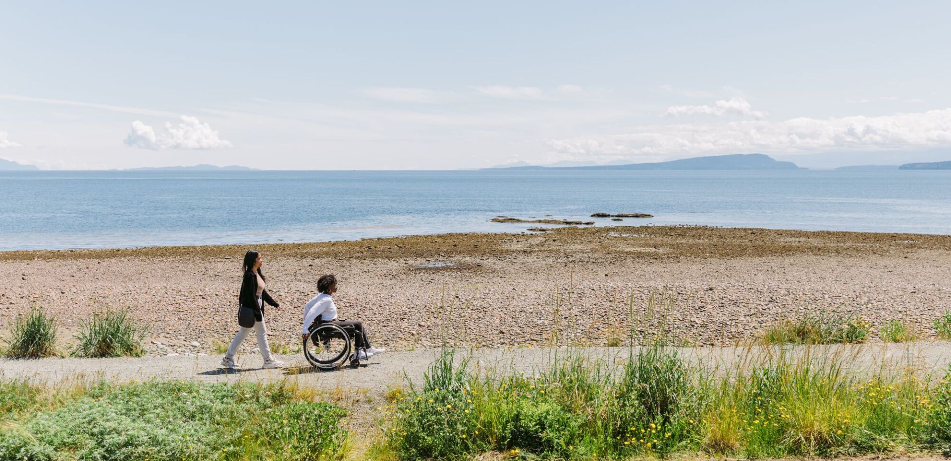 two people enjoying the seaside accessible trail at Point Holmes near Comox